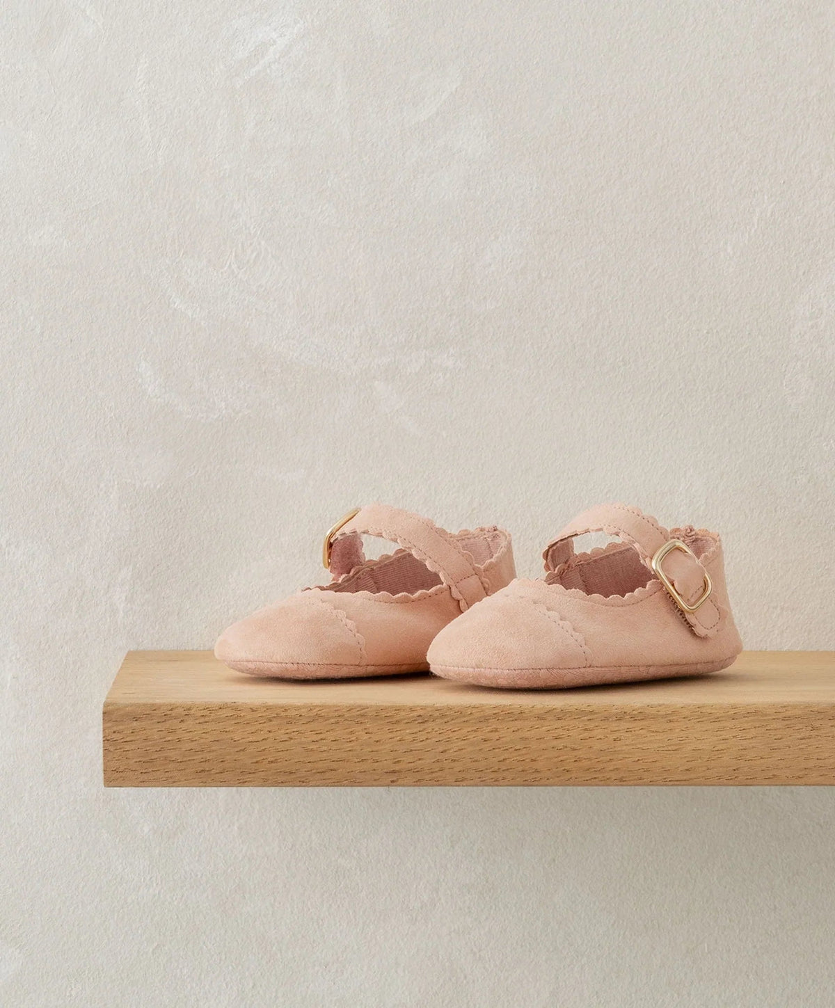 Pink scallop pram shoes with ruffled trim and ankle buckle strap
