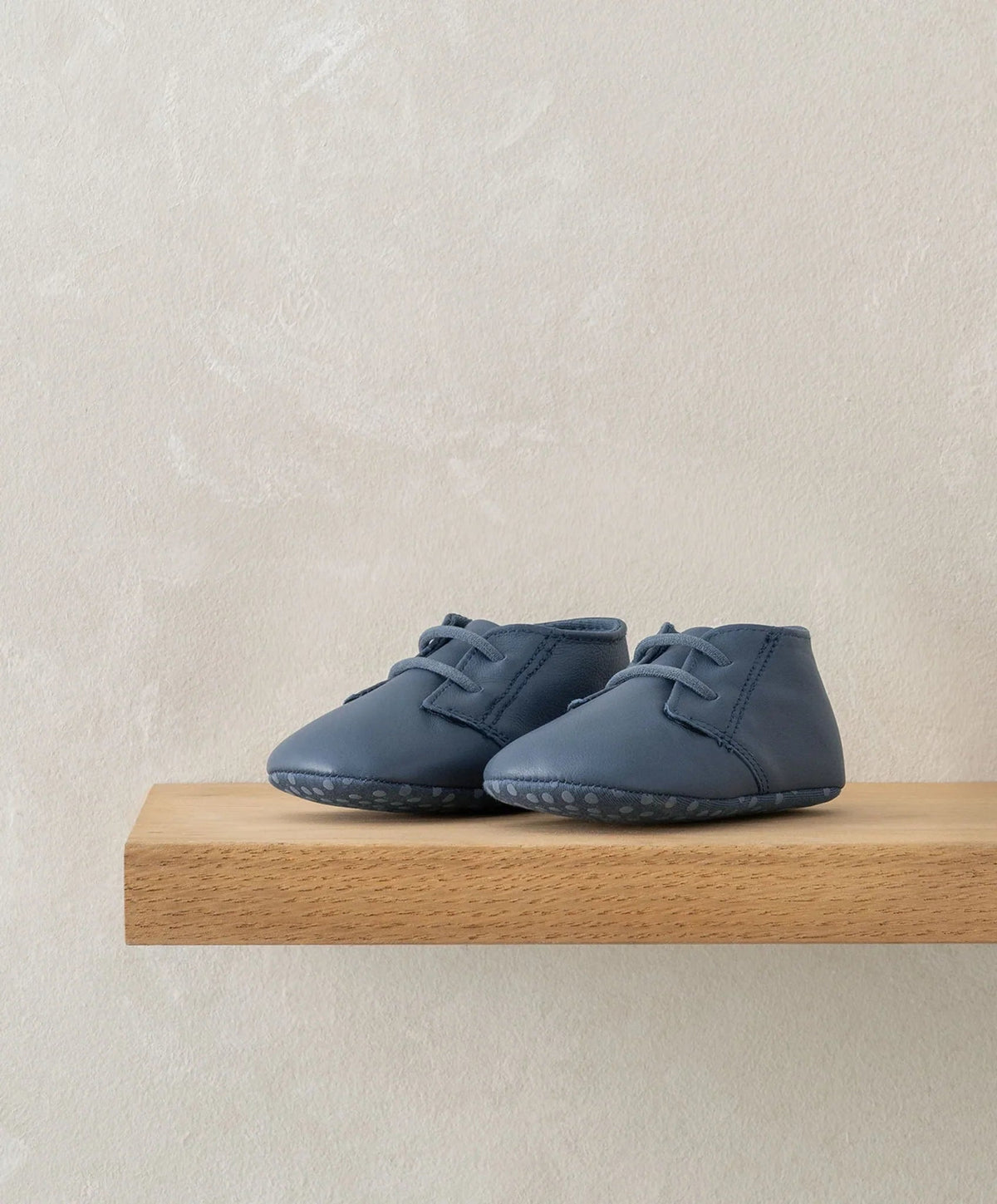 Navy pram shoes with lace-up front and scalloped trim