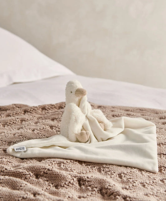 Cream plush duckling comforter with attached soft fabric blanket and hanging toy