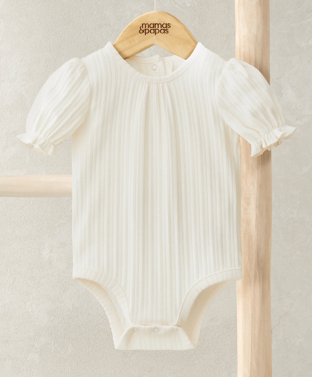 Off-white ribbed jersey short-sleeve bodysuit with puff sleeves and snap front