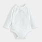 White long-sleeve baby bodysuit with snap closures at legs and small chest print