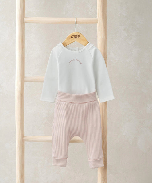 White long-sleeve bodysuit with light pink ribbed leggings, cuffed ankle hems