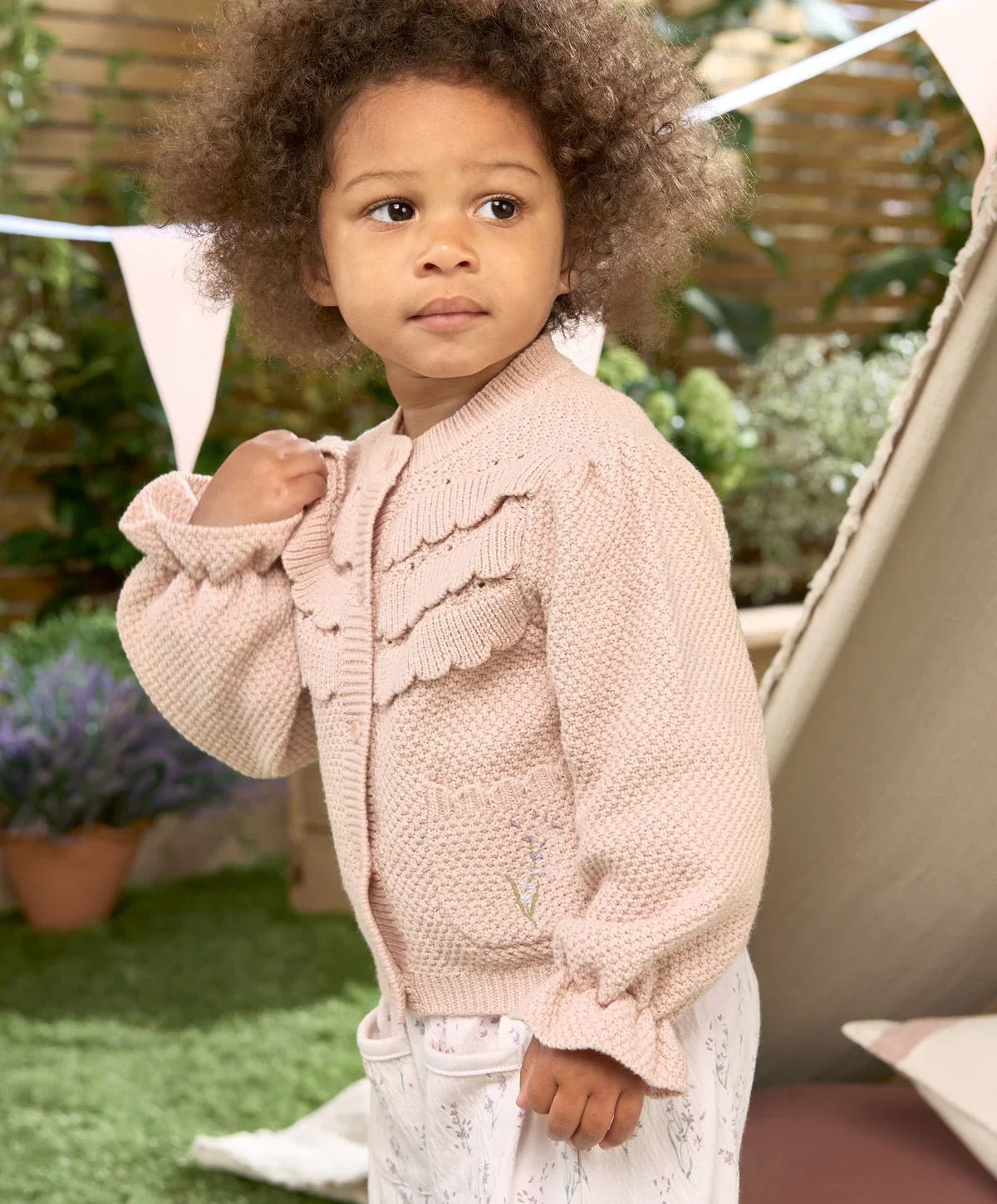 Light pink embroidered button cardigan with textured panels and long sleeves