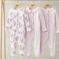 Three long-sleeve sleepsuits: floral white, pale pink, and pink ditsy print