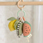 Fruit-themed linkable activity toy with hanging plush pieces on a ring