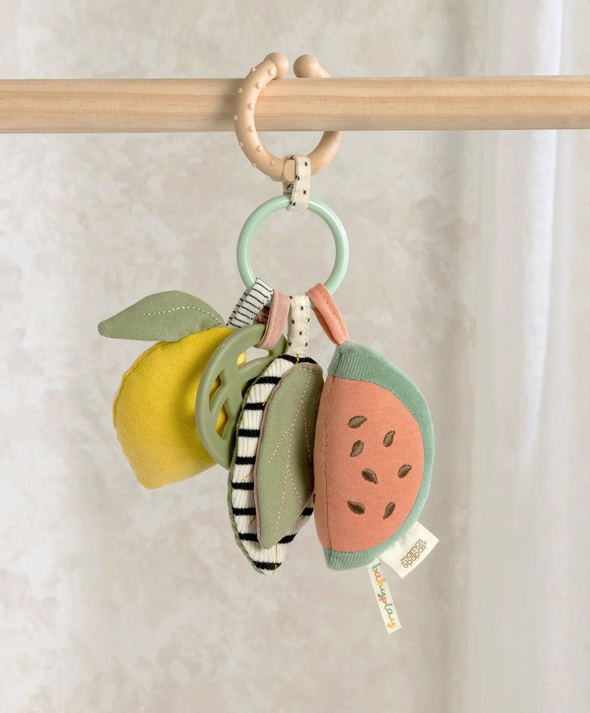 Fruit-themed linkable activity toy with hanging plush pieces on a ring