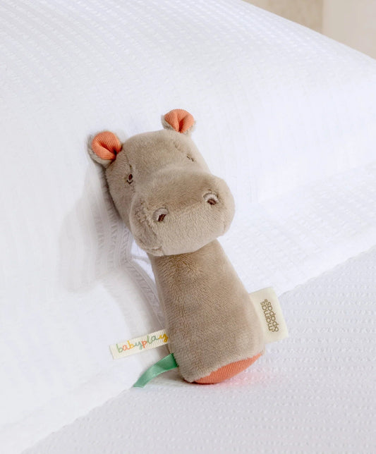 Gray plush hippo mini rattle with orange ears and fabric tag