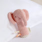 Pink mini elephant plush rattle with dangling tail and fabric ears