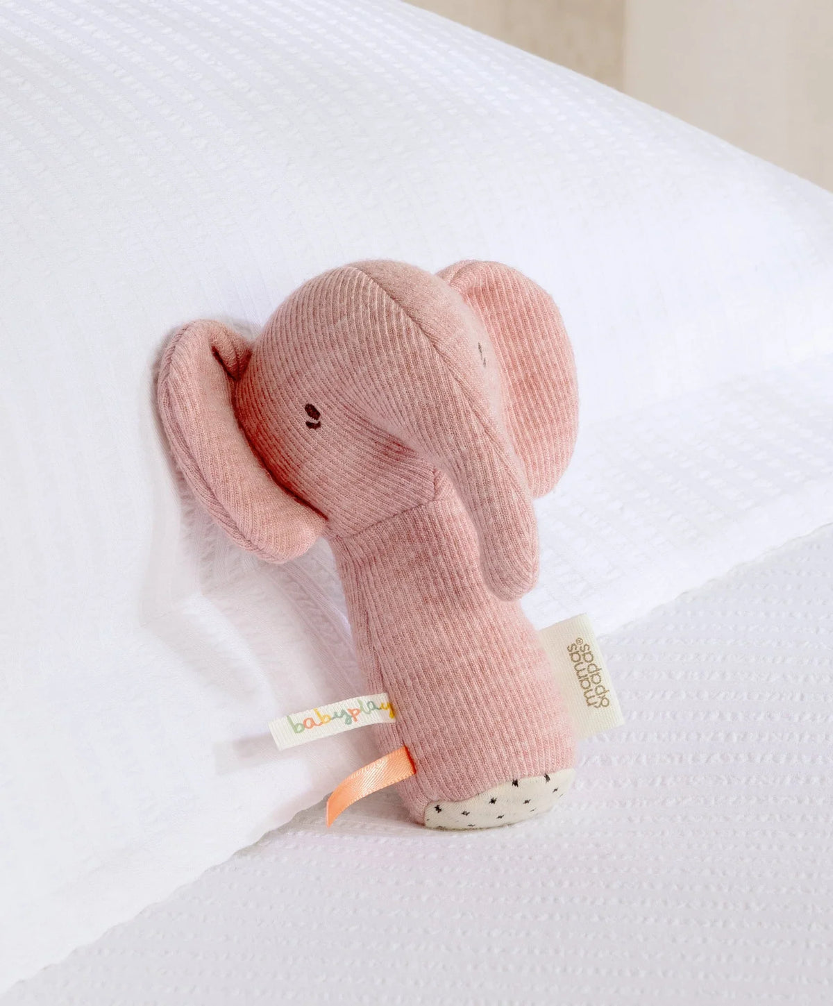 Pink mini elephant plush rattle with dangling tail and fabric ears