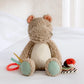 Plush activity toy hippo with textured beige body, mint feet, and dangling toys