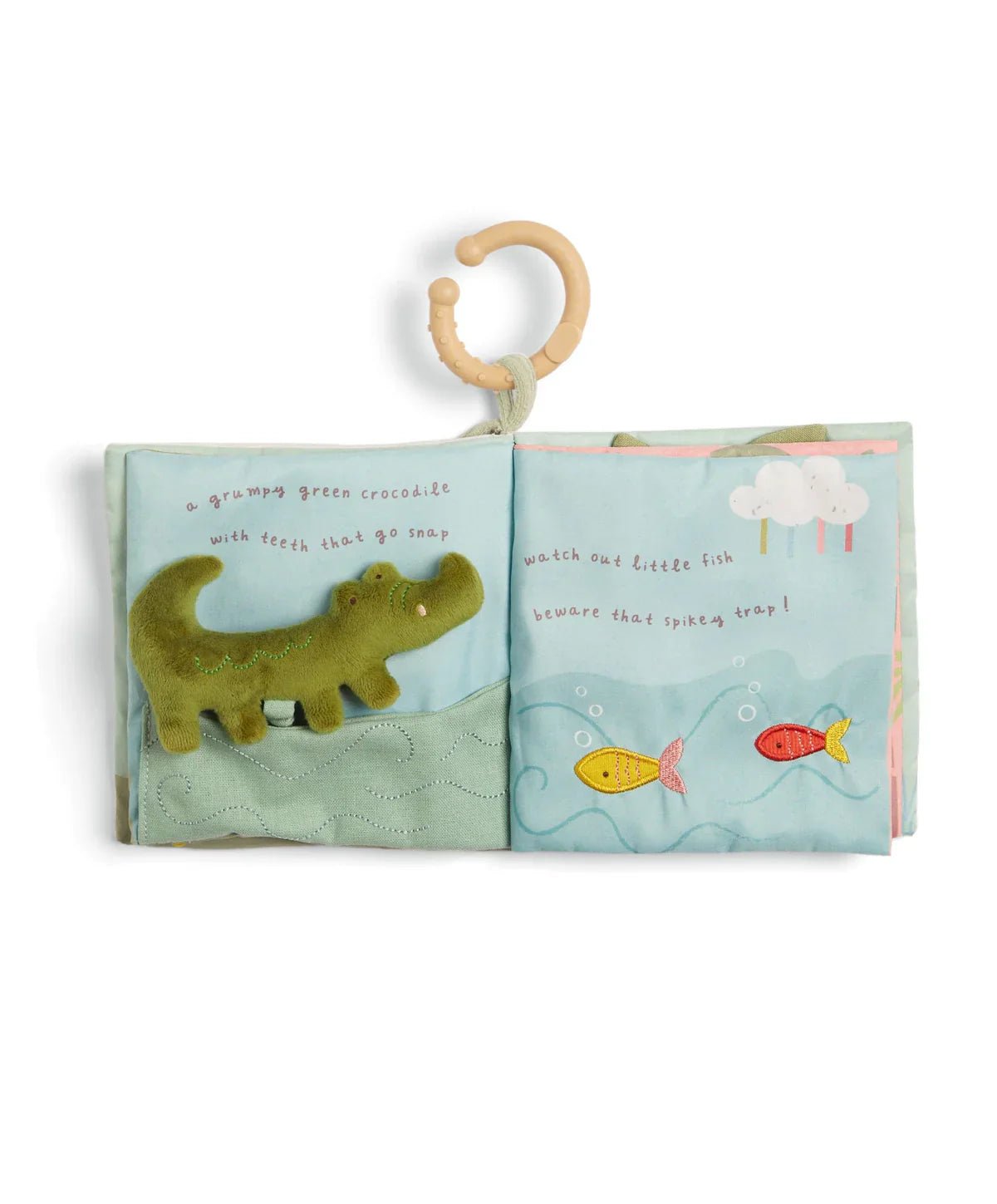 Baby cloth activity book open to dinosaur and fish scenes on fabric pages