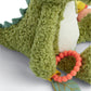 Green plush crocodile toy leg with orange bead ring and blue stitched fabric fin