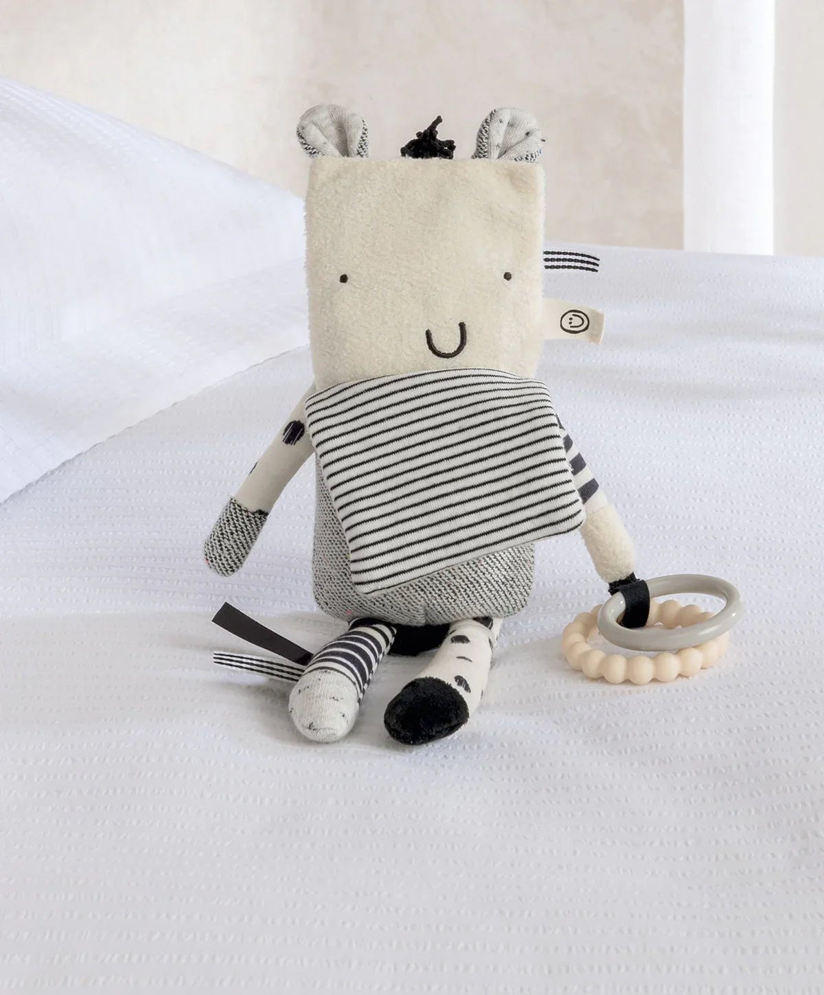 Plush zebra activity toy with striped body and fabric face, with ring teether