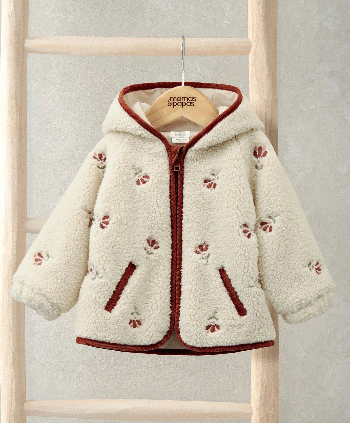 Cream hooded borg jacket with front zip and burgundy trim, embroidered cherry accents