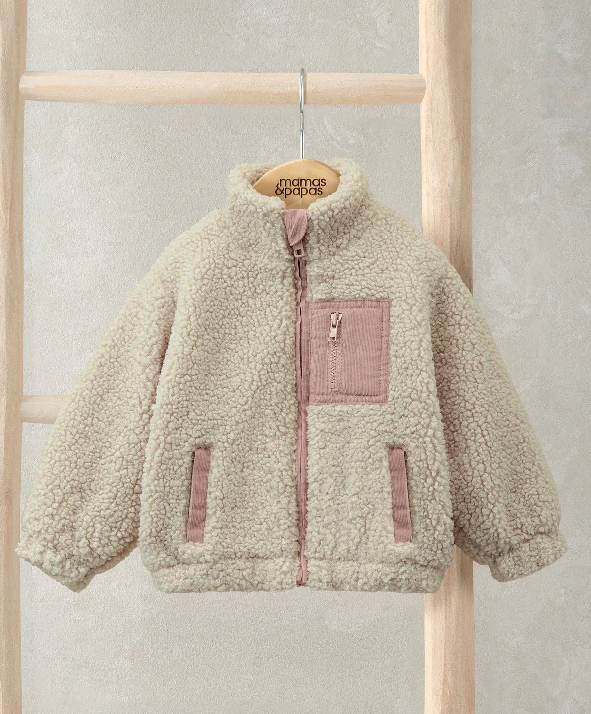 Cream borg jacket on hanger, funnel neck, front zip, chest pocket and side pockets
