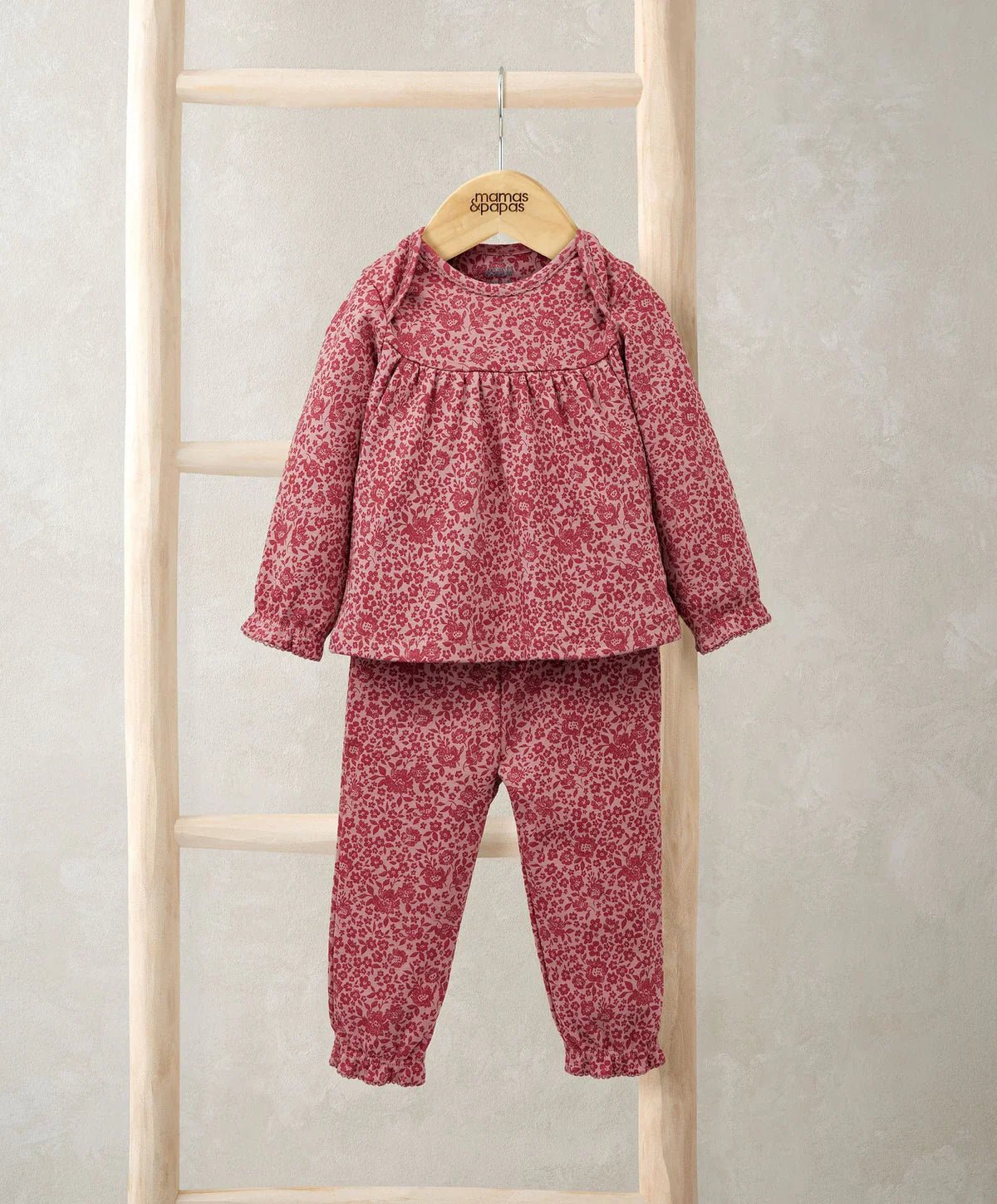 Pink floral pyjama set with long-sleeve top and matching ankle-length pants