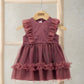 Dusty pink tulle dress with ruffled shoulders and tiered ruffle skirt