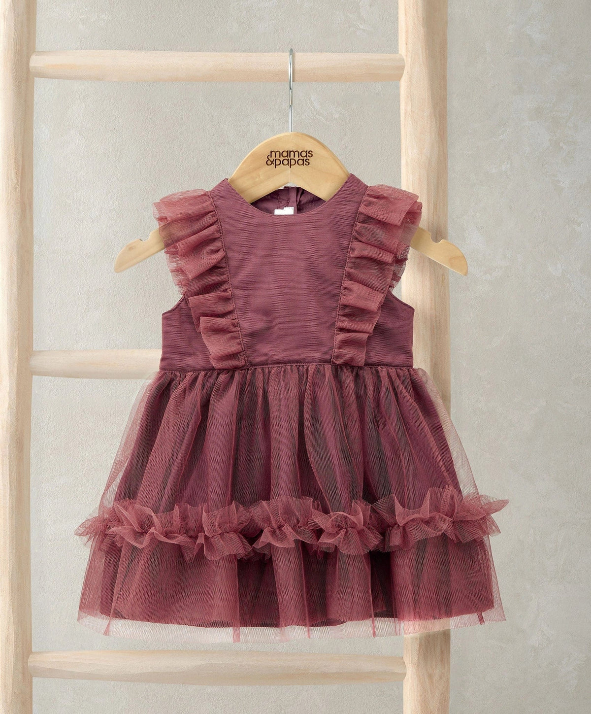 Dusty pink tulle dress with ruffled shoulders and tiered ruffle skirt