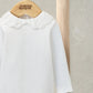 White bodysuit featuring embroidered Peter Pan collar with scalloped ruffle trim