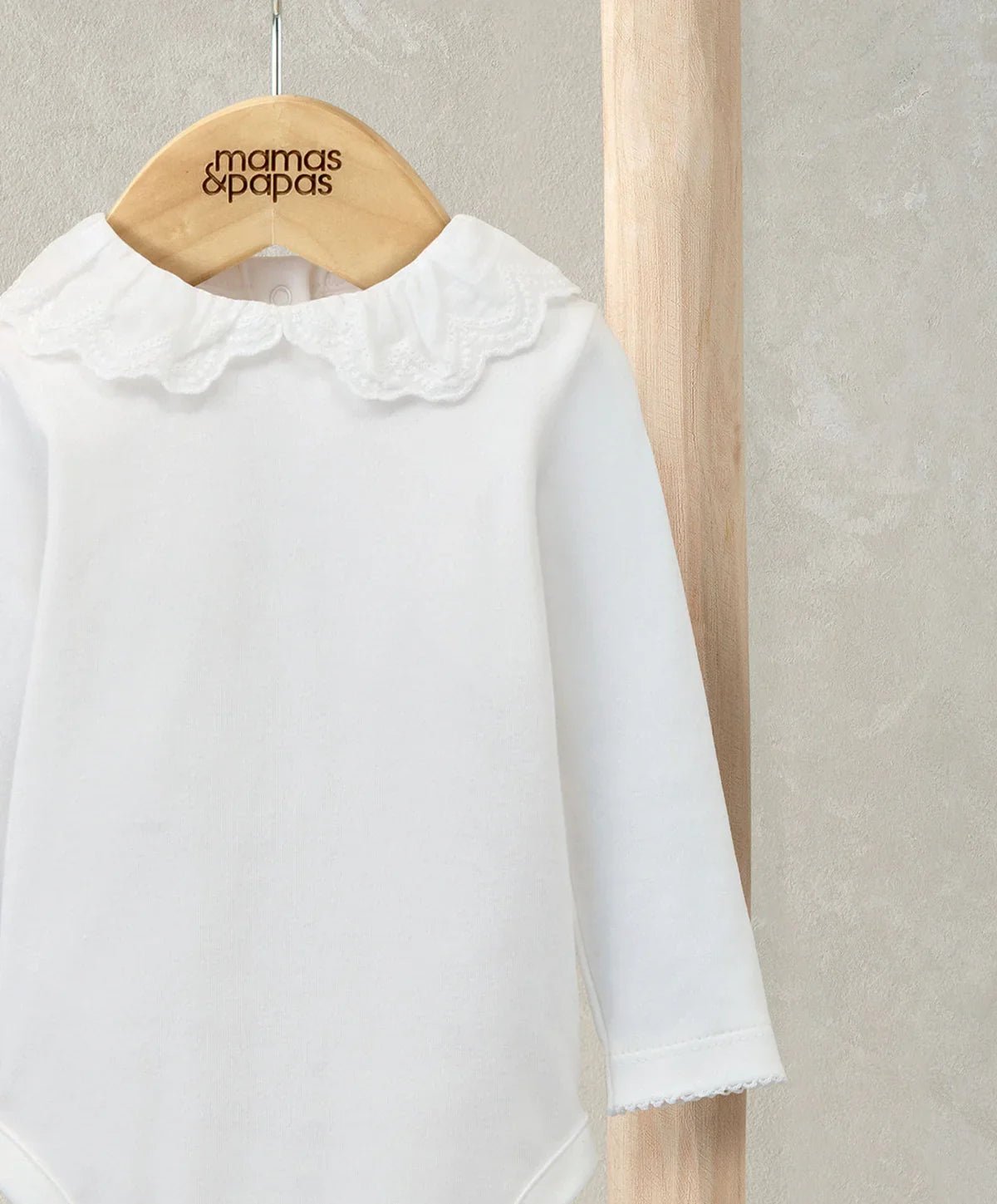 White bodysuit featuring embroidered Peter Pan collar with scalloped ruffle trim