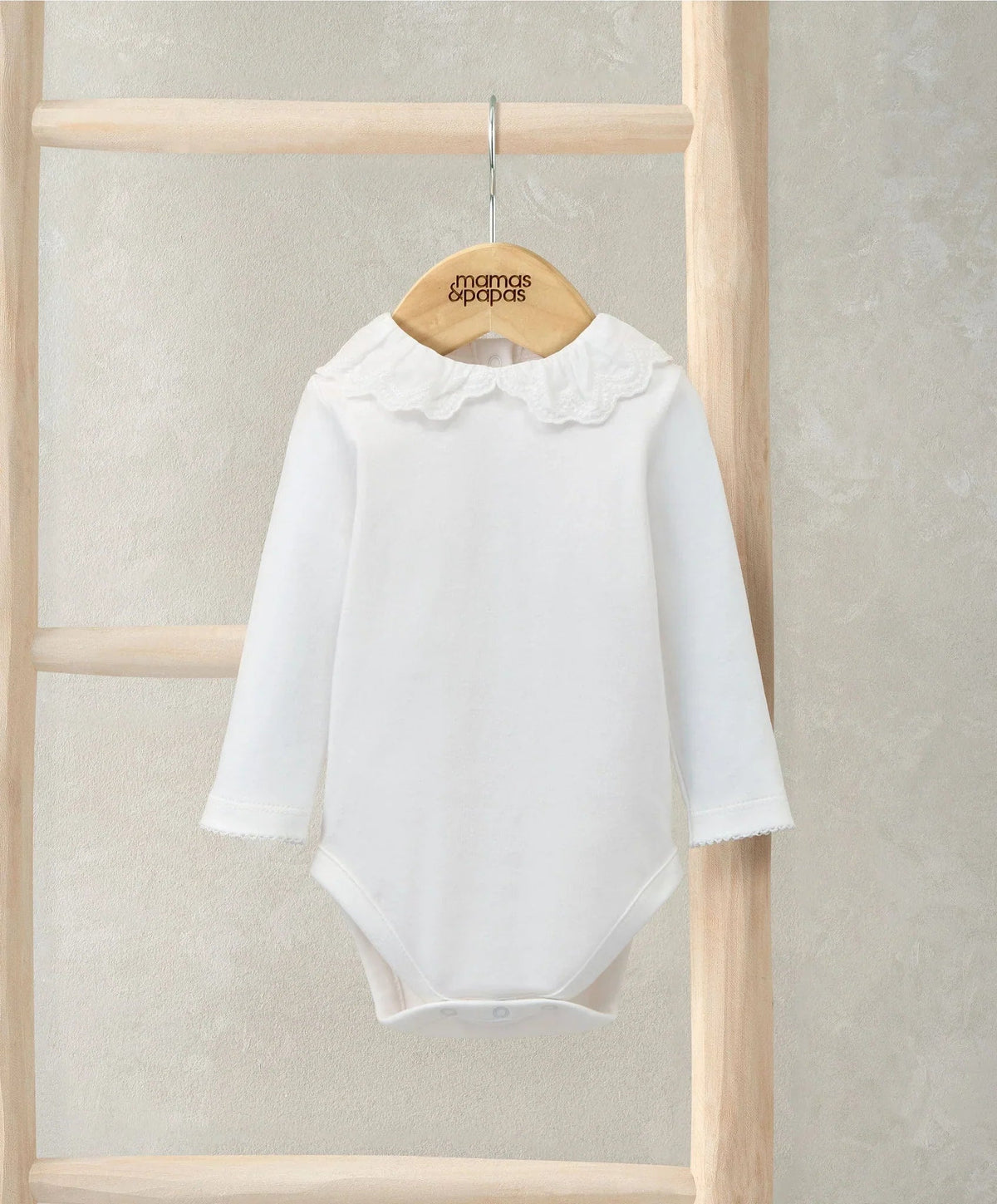 White long-sleeve bodysuit with embroidered Peter Pan collar and scalloped ruffles