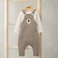 Baby knitted bear dungarees over a long-sleeve cream bodysuit, brown bear face patch