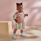 Two-piece floral dress and pink knit vest set on child with frilled neckline