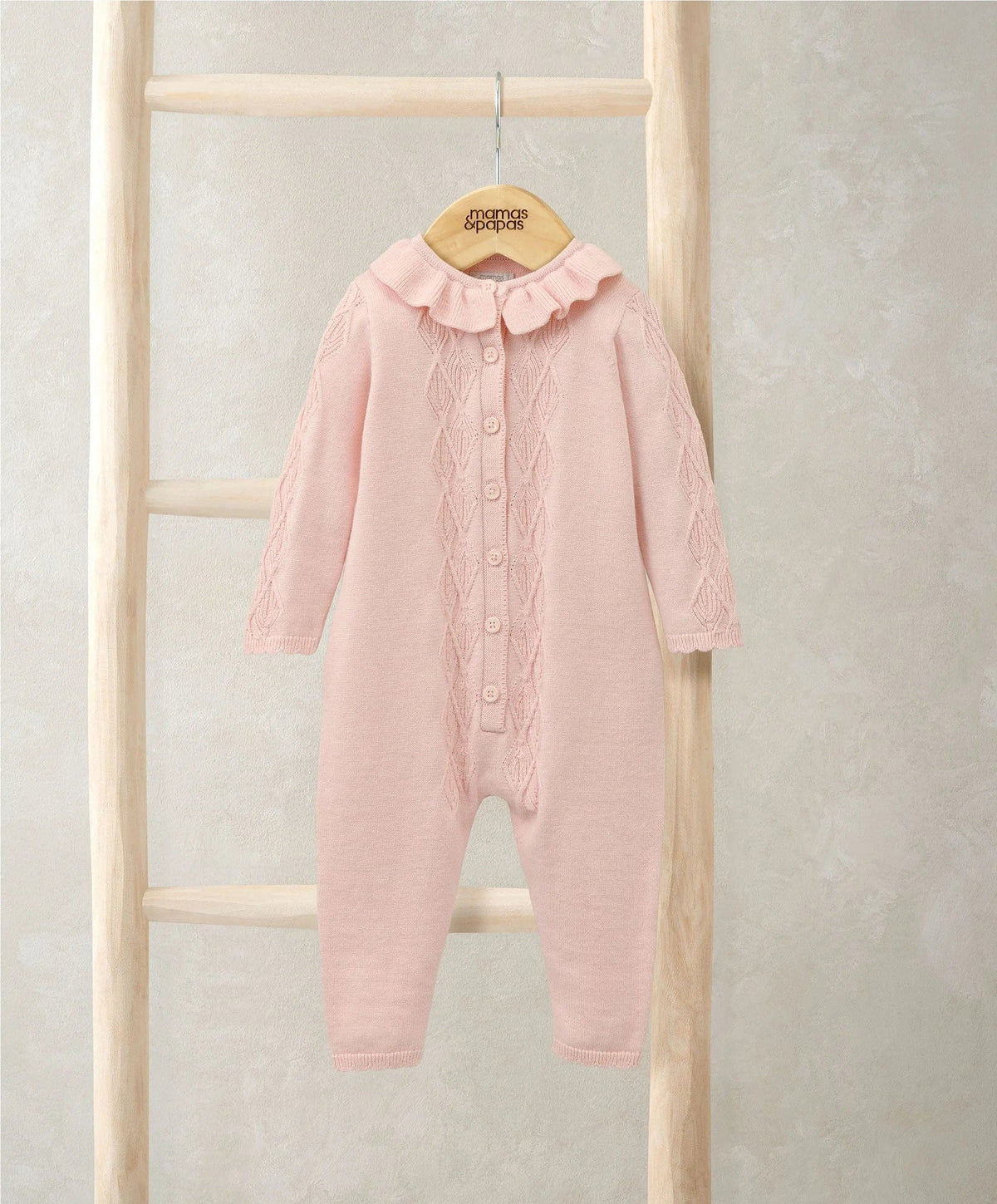 Pink knitted romper with frill collar, button front and long sleeves