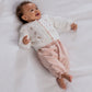 Baby wearing white embroidered cable knit cardigan with button front and floral accents