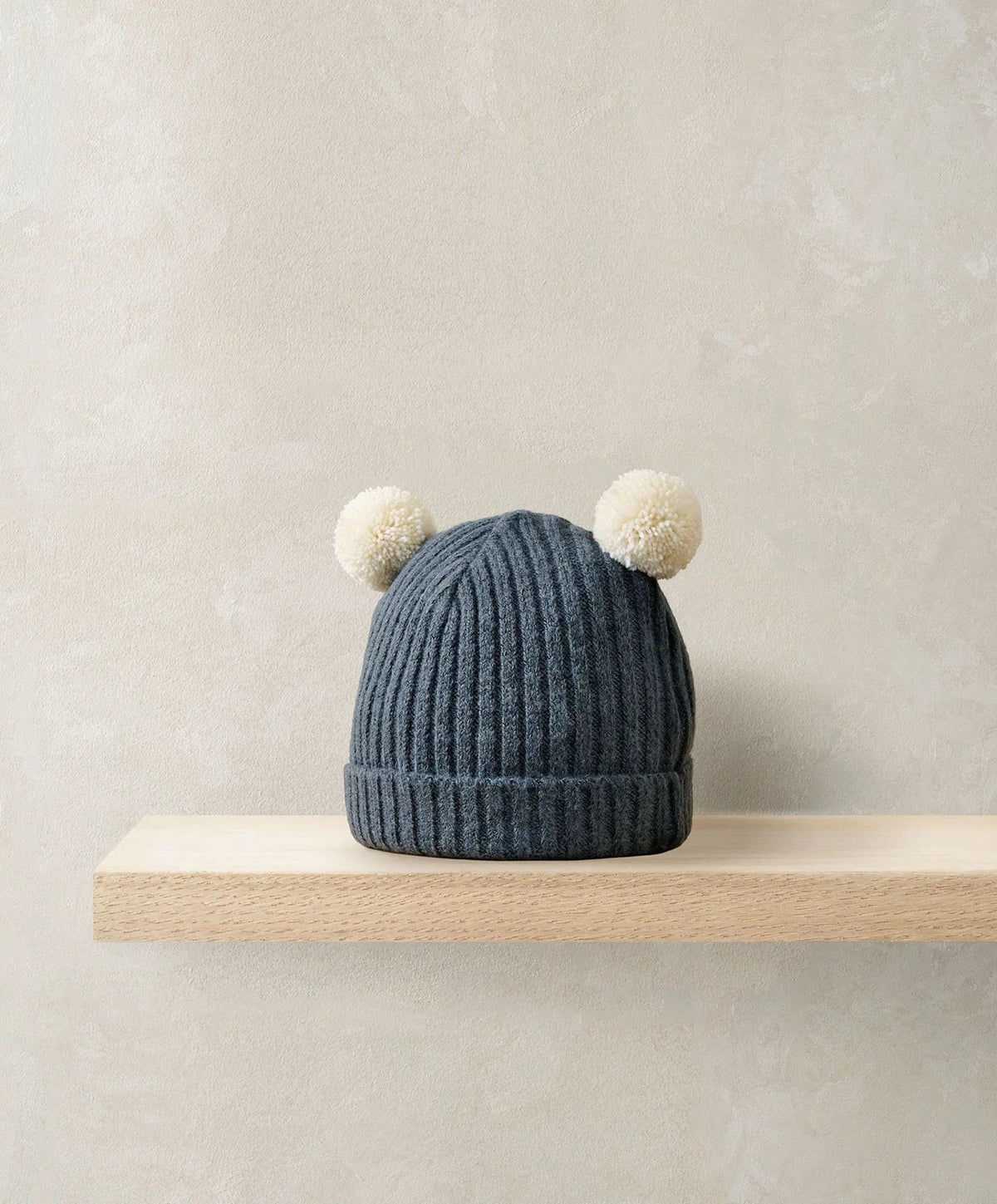 Blue rib knit beanie hat with two white pom-poms