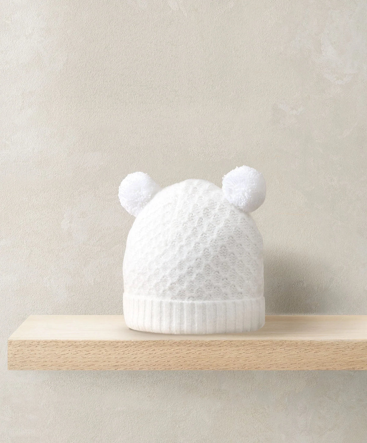 White rib knit beanie hat with pom poms and rounded ear cuffs