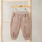 Pink cord trousers with elastic waistband and two front patch pockets
