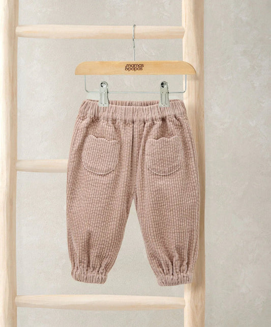 Pink cord trousers with elastic waistband and two front patch pockets