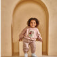 Pink sweatshirt with floral chest appliqué and balloon sleeves, worn with matching joggers
