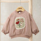 Pink sweatshirt with floral chest appliqué, ribbed hem and cuffs, balloon sleeves