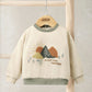 Cream crewneck sweatshirt with embroidered mountains and sunburst graphic, ribbed cuffs