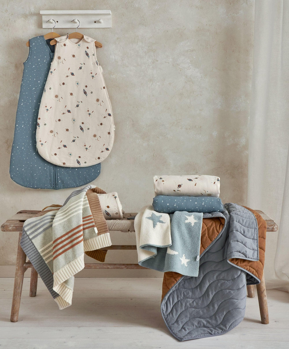 Cream and blue toddler sleep bags with planet-style prints, sleeveless