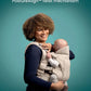 Black baby carrier with seated infant facing inward, parent wearing it