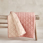 Baby quilt with pink and cream wavy stitched pattern, quilted padded blanket