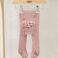 Light pink tights with ruffled bum panel, hanging on clips