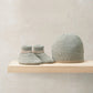 Knit baby booties and gray beanie set with ribbed cuffs and brim
