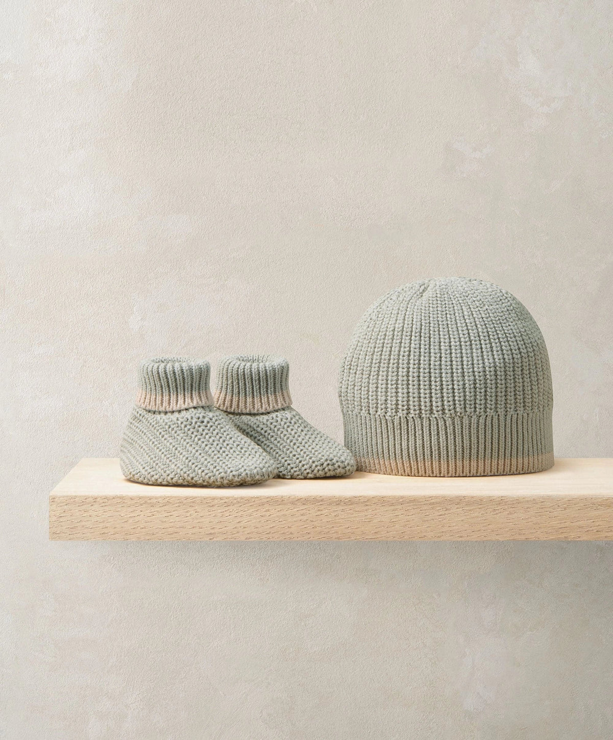 Knit baby booties and gray beanie set with ribbed cuffs and brim