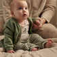 Baby in green button jacket with pockets, white bodysuit, and green gingham trousers.