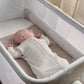 Oatmeal swaddle sleep bag in a crib with long zipper