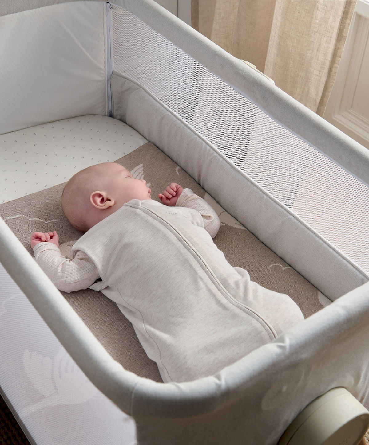 Oatmeal swaddle sleep bag in a crib with long zipper
