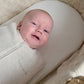 Oatmeal swaddle sleep bag with zipper, baby lying in it