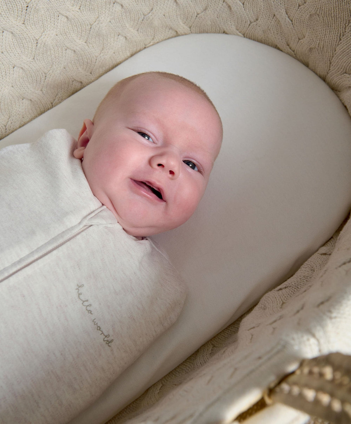 Oatmeal swaddle sleep bag with zipper, baby lying in it