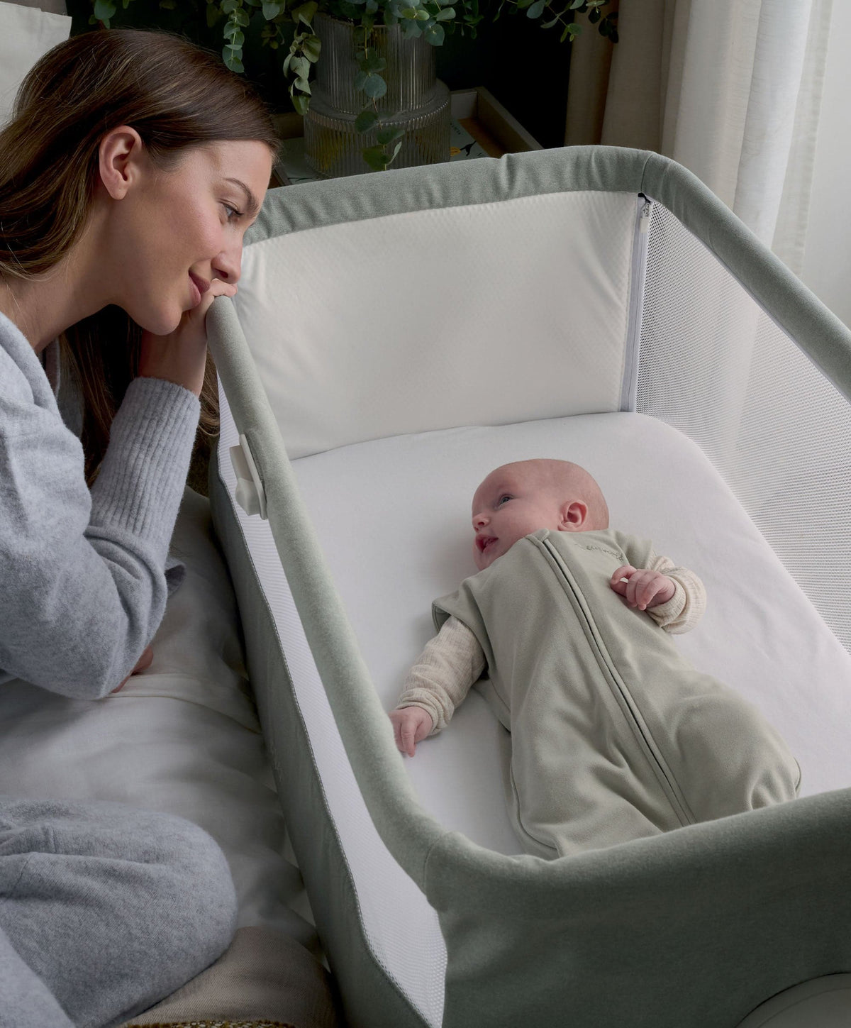 Sage baby swaddle sleep bag in bassinet, front zipper visible