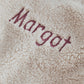 Cream borg fabric with embroidered word in burgundy thread