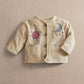 Cream kids jacket with front buttons, sun and moon embroidery, and two chest pockets